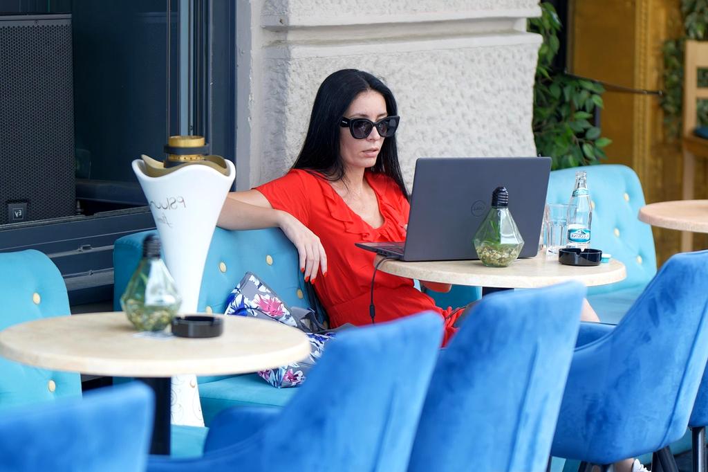 Person working remotely using futuristic digital devices